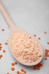 Photo of Spoon of lentil flour and seeds on white table, closeup