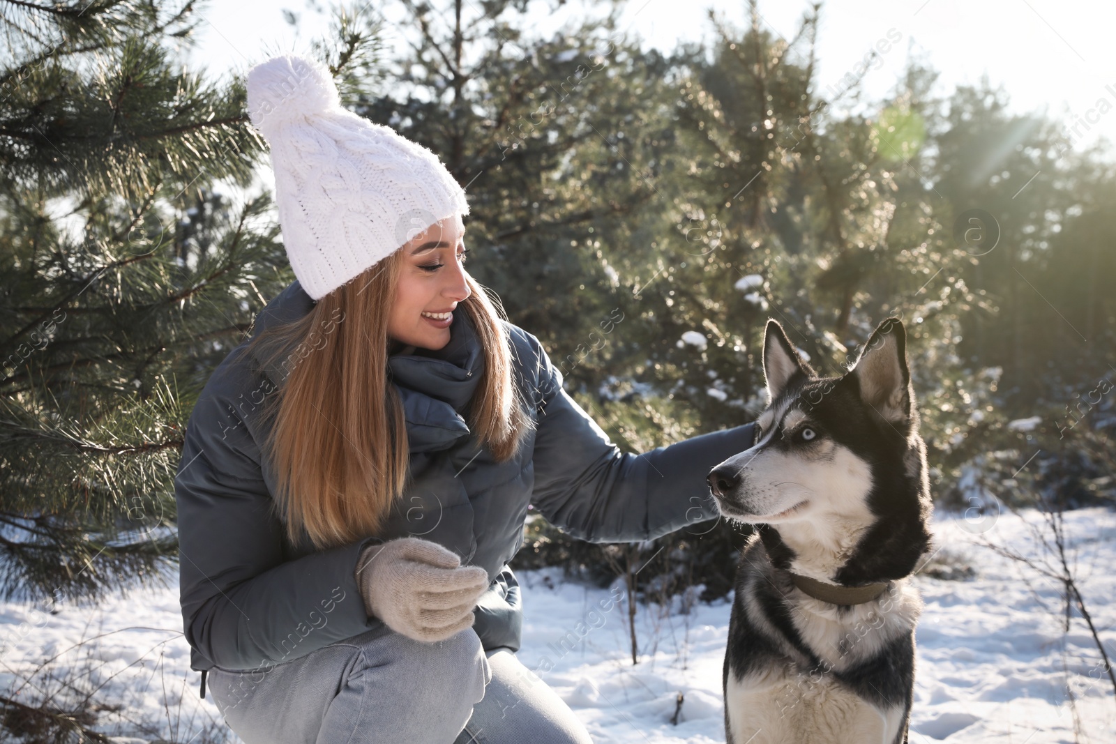 Photo of Young woman with dog in forest on winter day