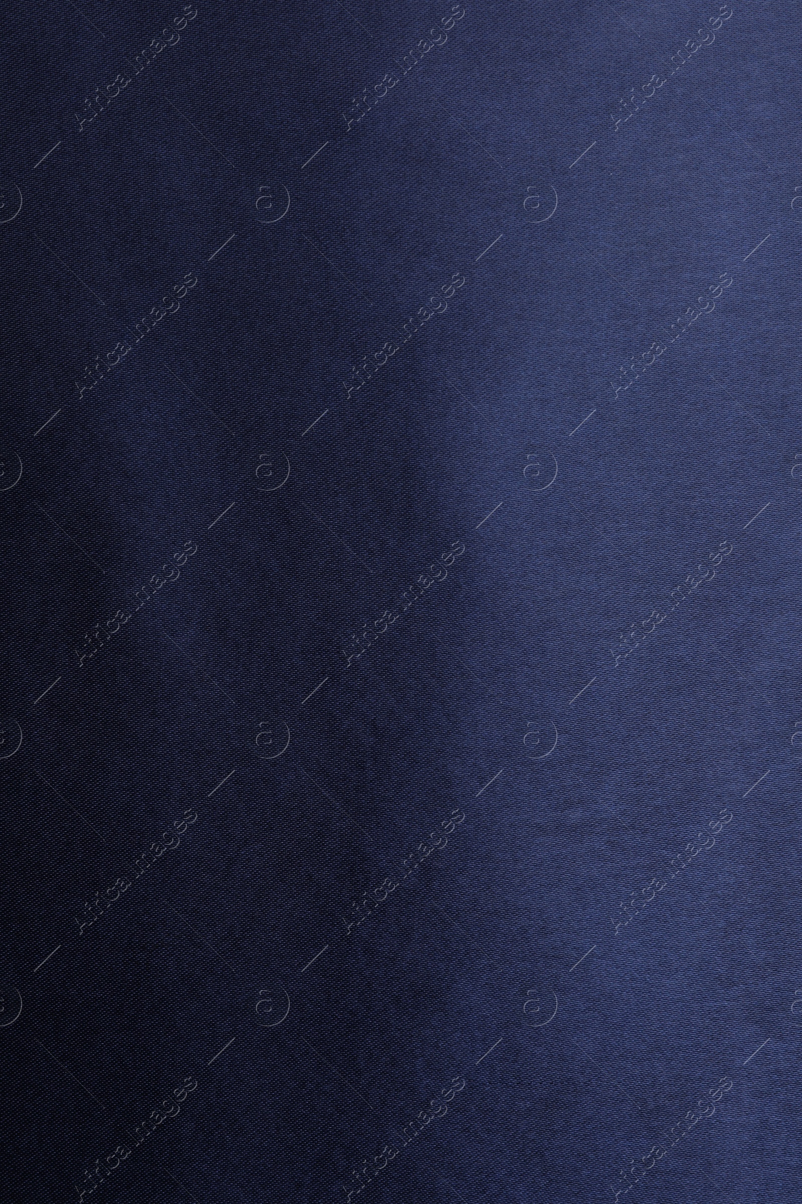 Photo of Texture of dark blue silk fabric as background, top view