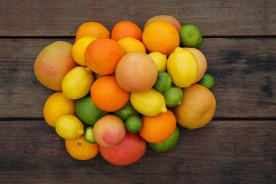Photo of Different citrus fruits on wooden table, flat lay