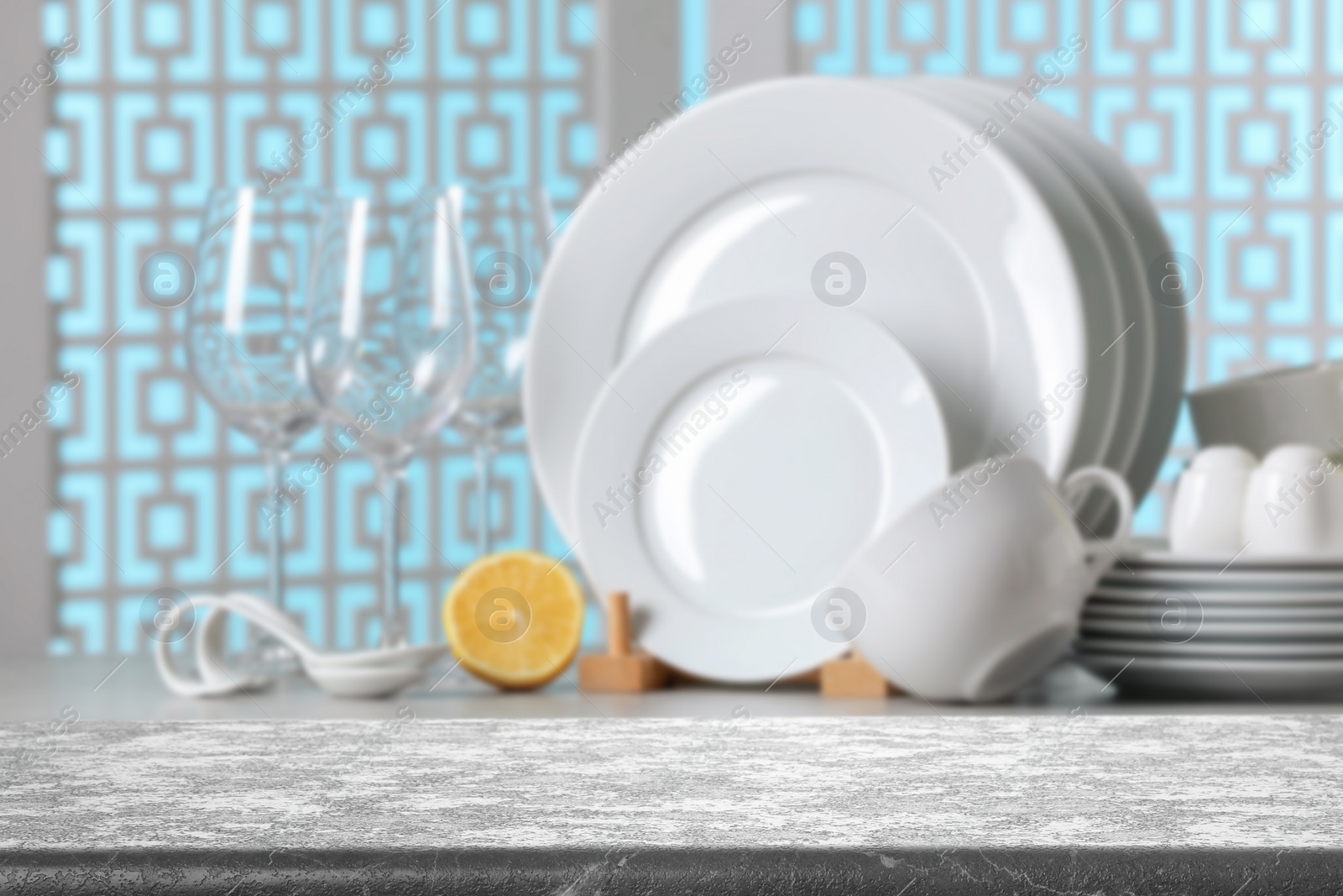 Image of Set of clean dishware, focus on empty stone table