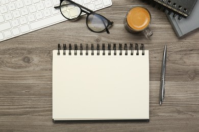 Photo of Flat lay composition with notebooks on wooden table