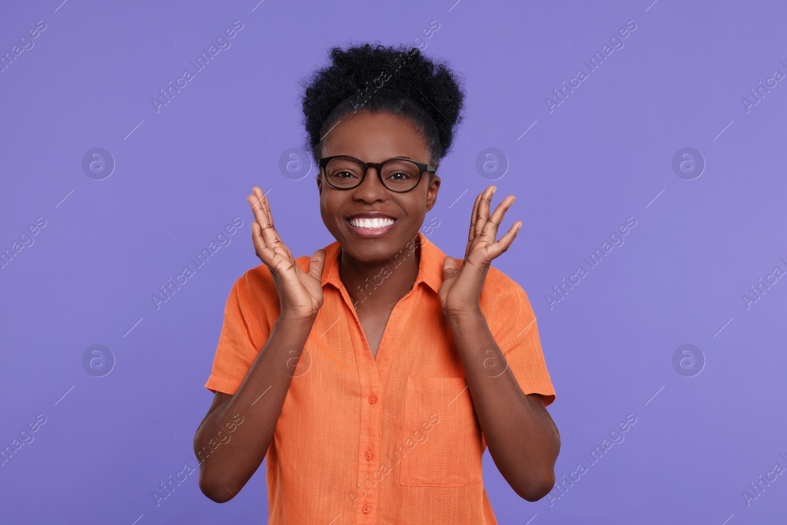 Photo of Portrait of happy young woman on purple background