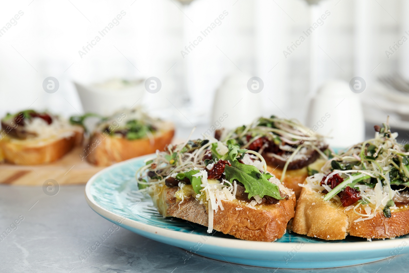 Photo of Delicious bruschettas with beef and cheese on marble table, closeup