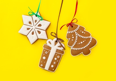Photo of Different delicious Christmas cookies on yellow background, flat lay