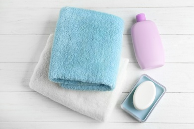 Photo of Flat lay composition with fresh towels on white wooden table