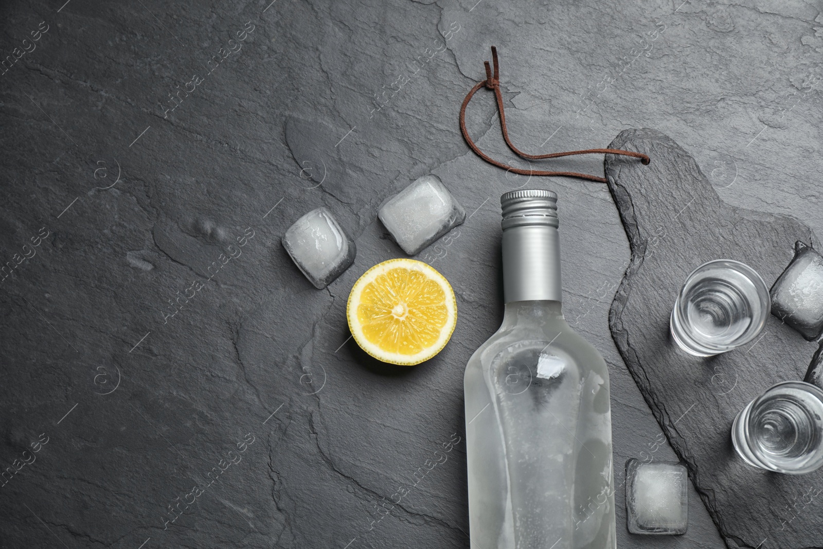 Photo of Flat lay composition with cold Russian vodka on black table