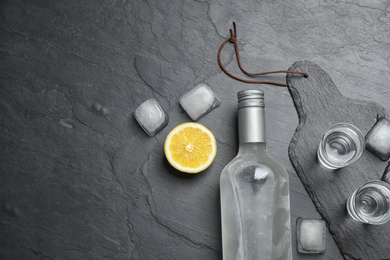 Photo of Flat lay composition with cold Russian vodka on black table