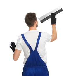 Professional worker in uniform with putty knife on white background, back view