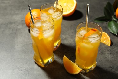 Photo of Delicious orange soda water on grey table