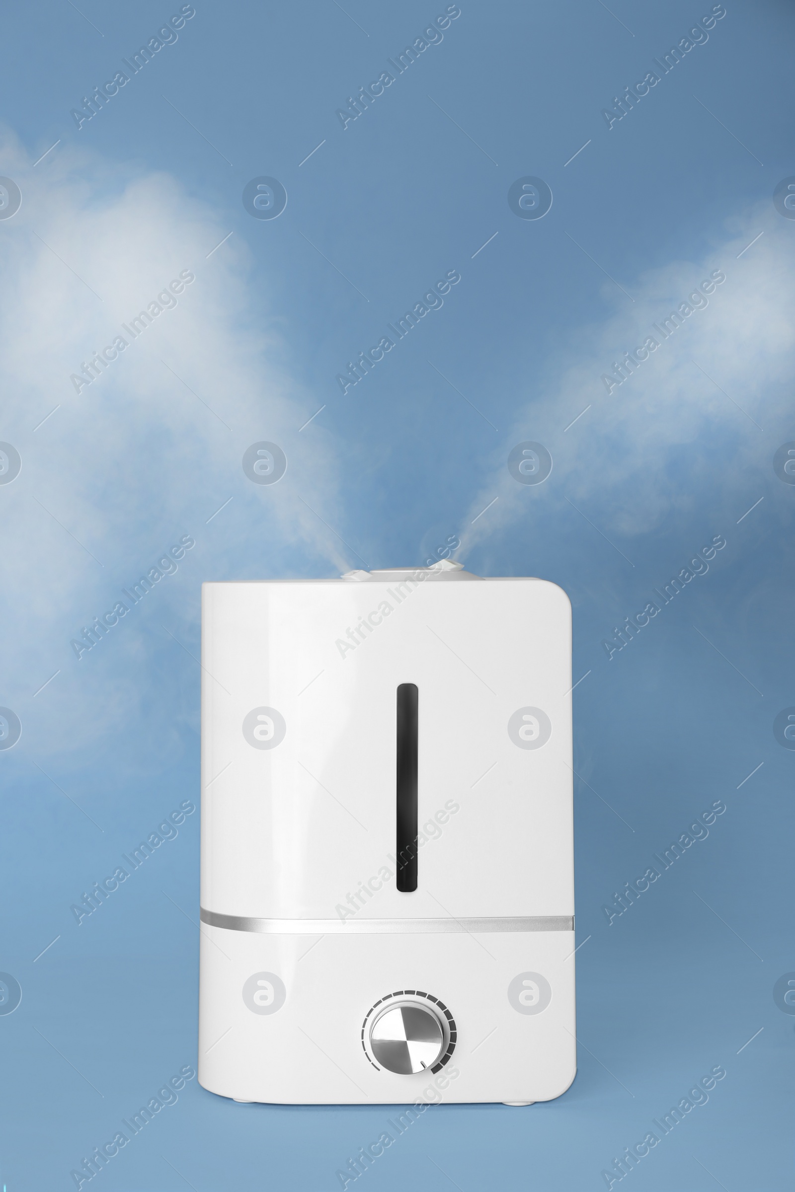 Photo of Modern air humidifier on light blue background