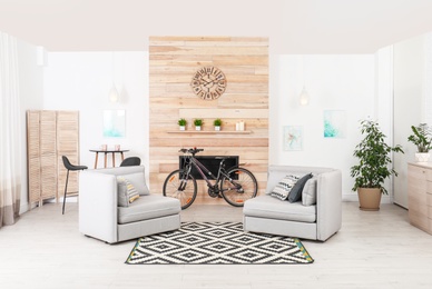 Photo of Bicycle near wooden wall in stylish room interior
