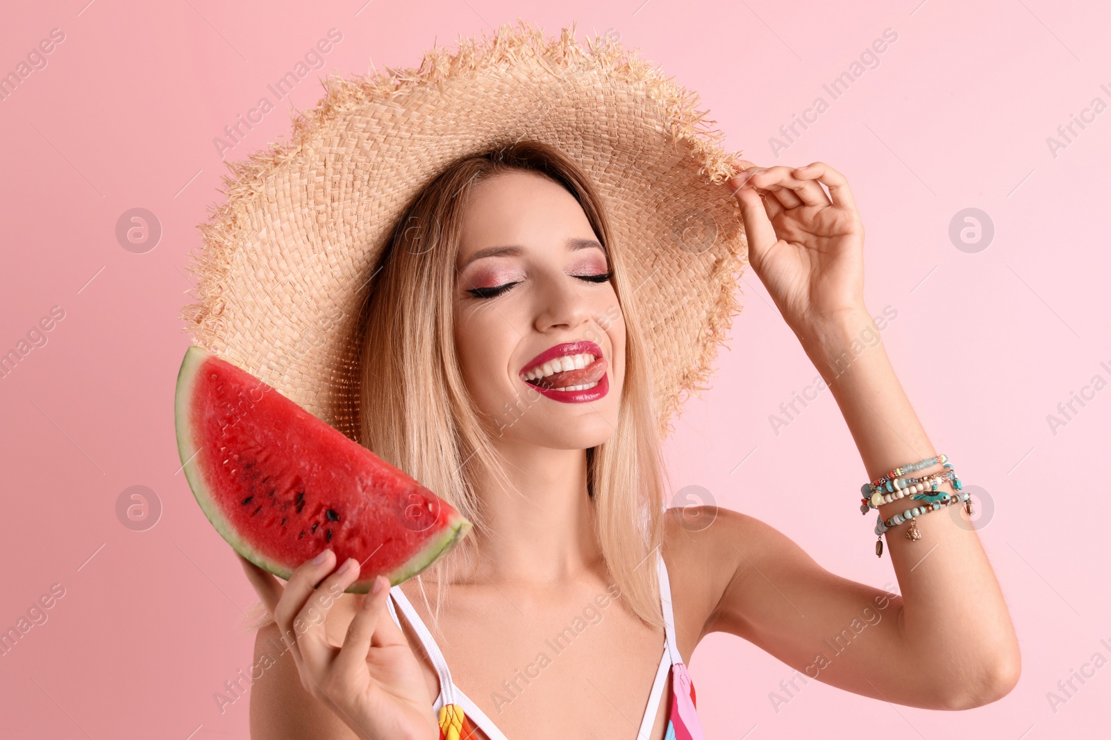 Photo of Pretty young woman with juicy watermelon on color background