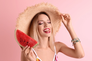 Pretty young woman with juicy watermelon on color background