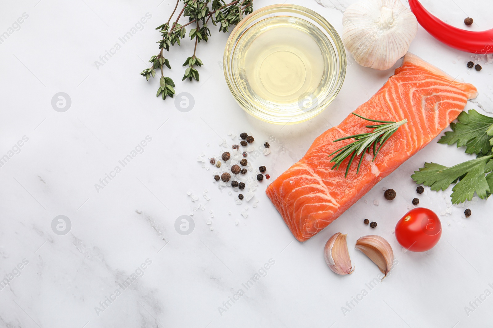 Photo of Fresh salmon and ingredients for marinade on white marble table, flat lay. Space for text