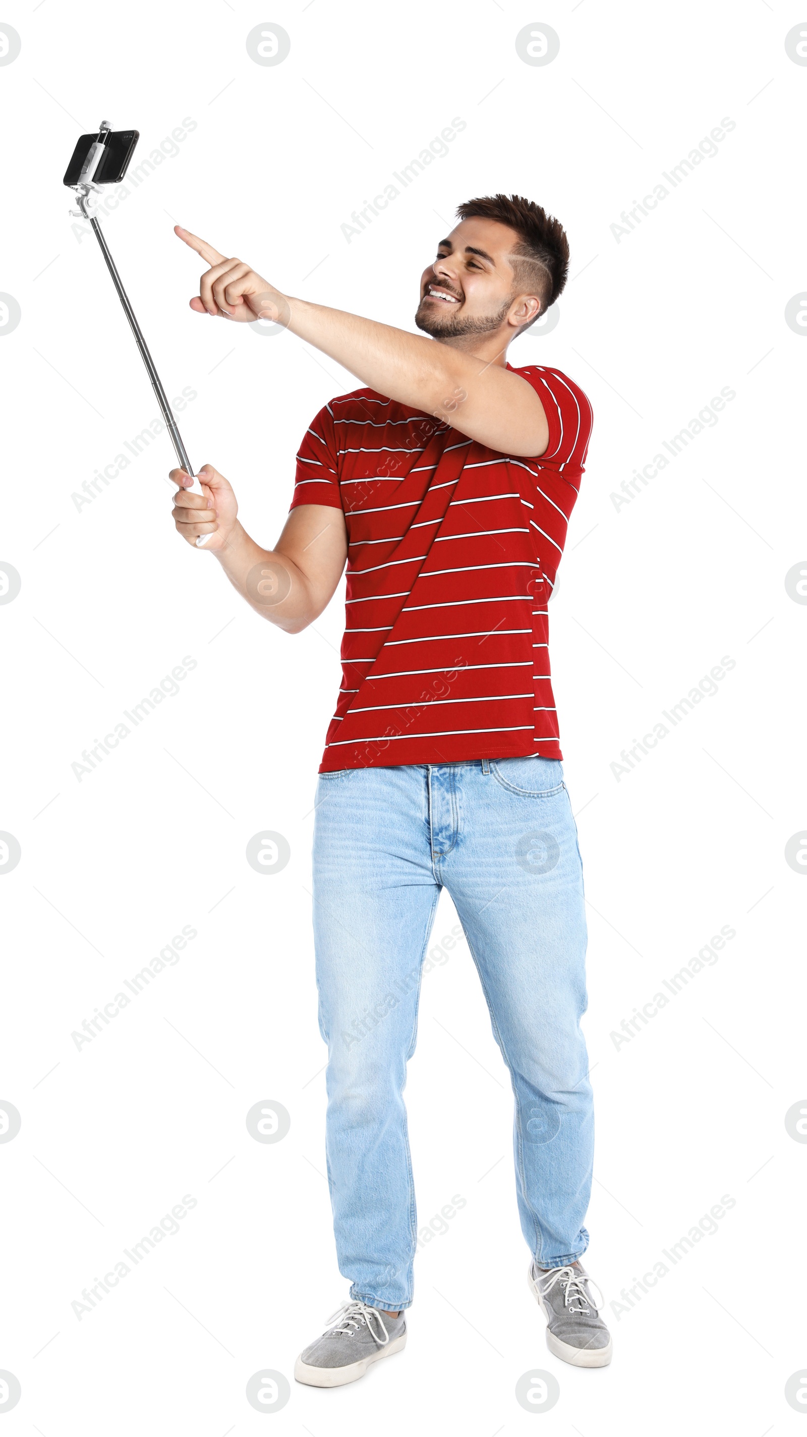 Photo of Happy young man taking selfie on white background