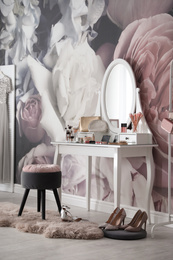 Stylish room interior with elegant dressing table and floral wallpaper