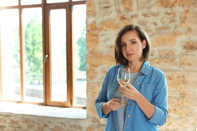 Photo of Woman with glass of white wine indoors