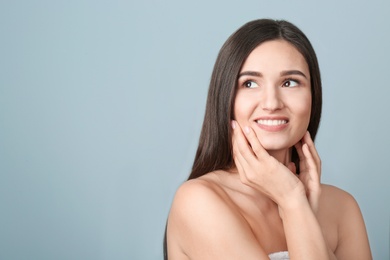 Photo of Portrait of beautiful woman on color background. Cosmetology and spa