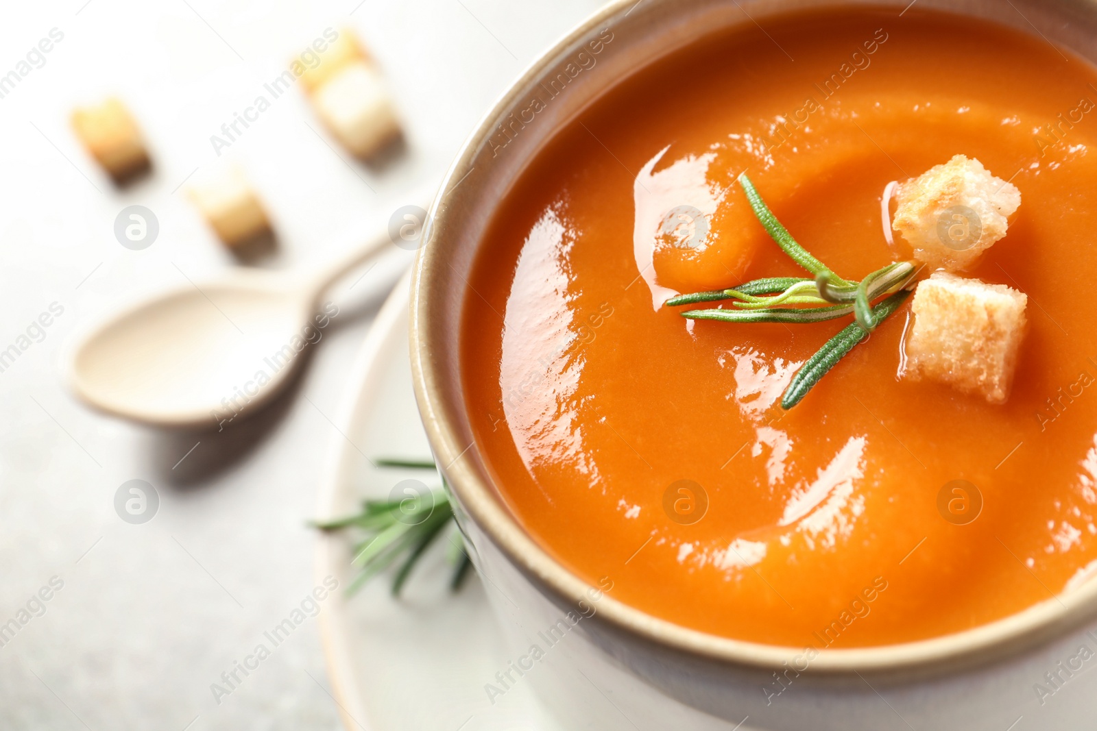 Photo of Mug of tasty sweet potato soup on table, closeup