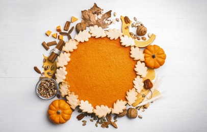 Flat lay composition with delicious homemade pumpkin pie on white wooden table