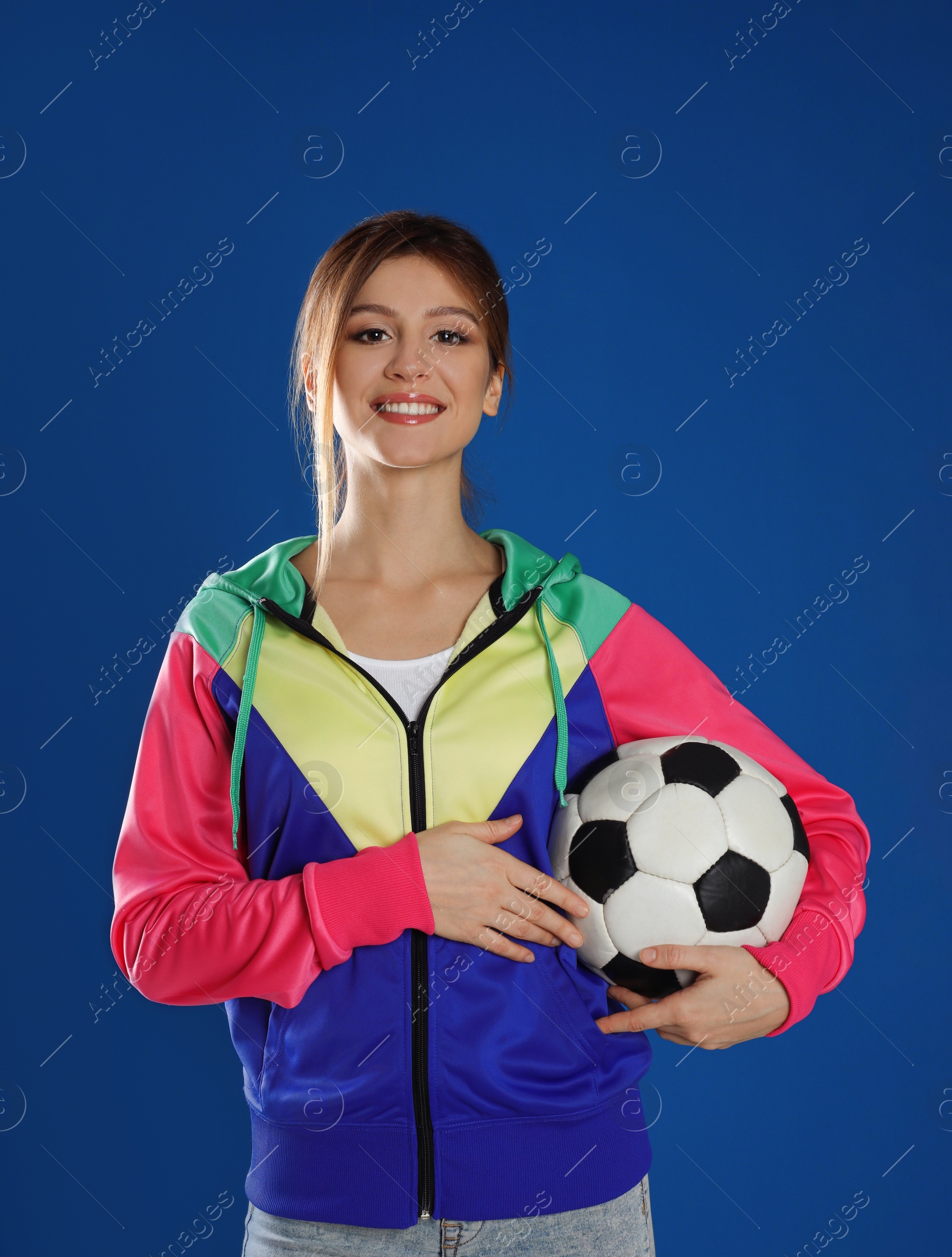 Photo of Happy woman with soccer ball on blue background