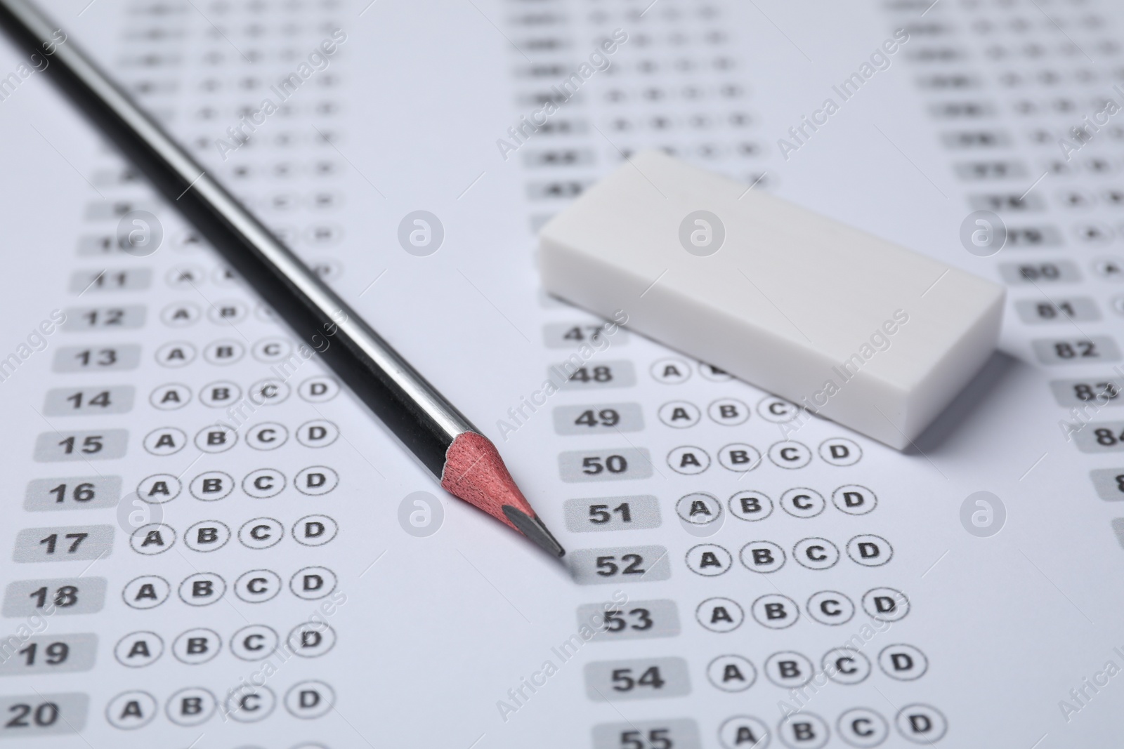 Photo of Pencil and eraser on answer sheet, closeup. Student passing exam