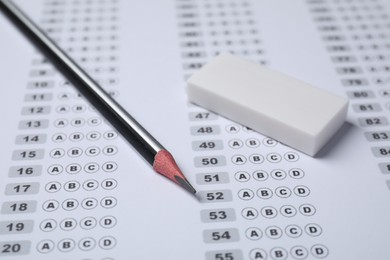 Photo of Pencil and eraser on answer sheet, closeup. Student passing exam