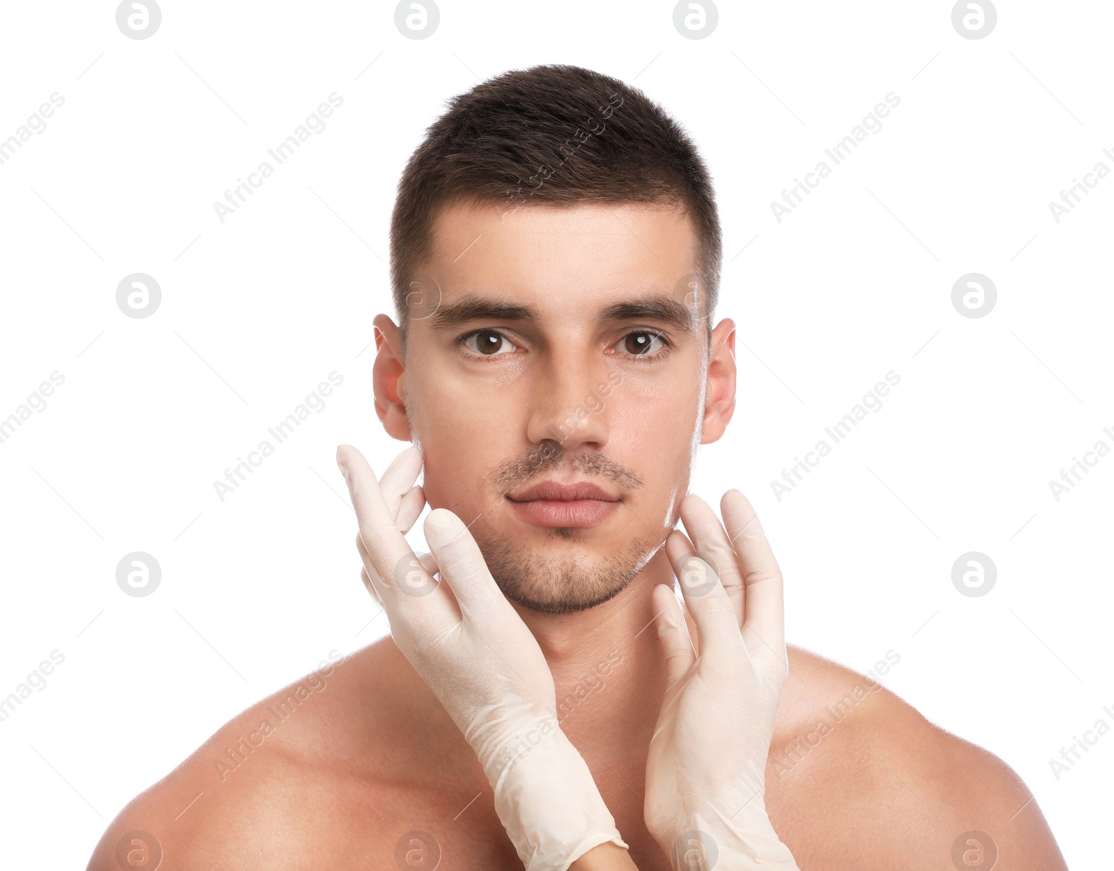 Photo of Doctor examining man's face for cosmetic surgery on white background