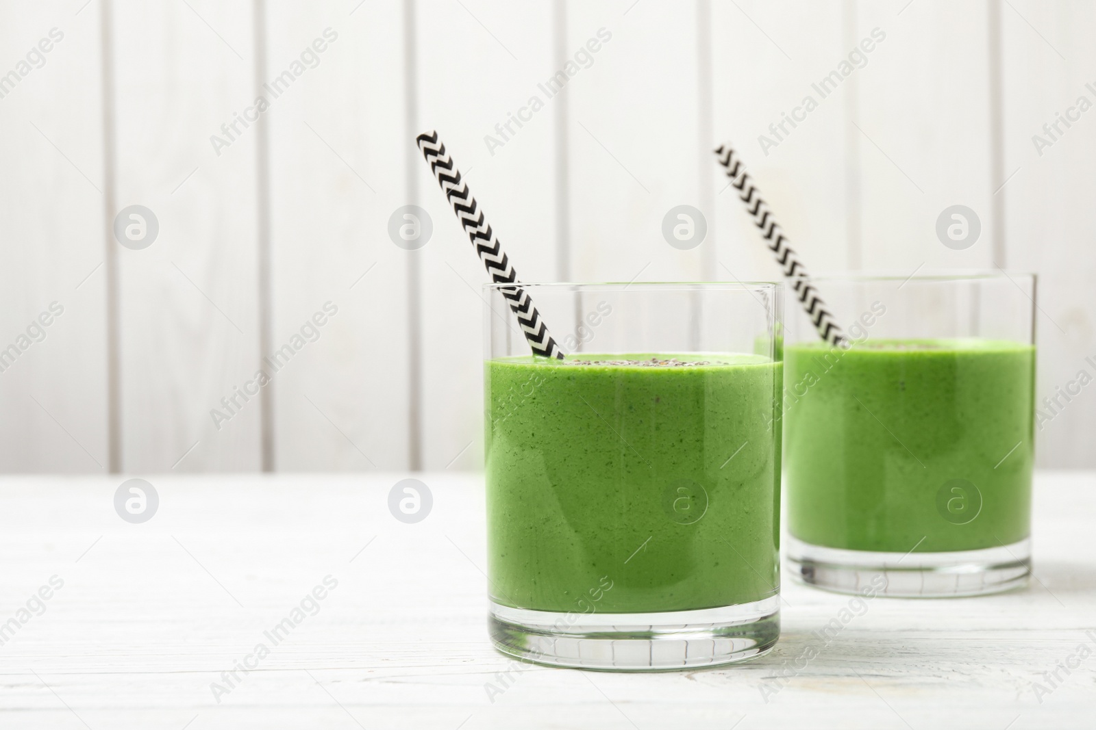 Photo of Tasty kale smoothie on white wooden table