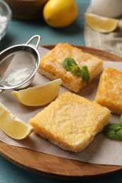 Photo of Tasty lemon bars and mint on table, closeup