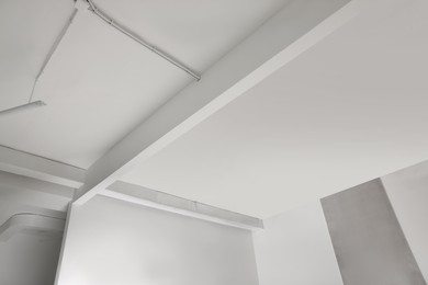 Ceiling with modern ventilation system in renovated room