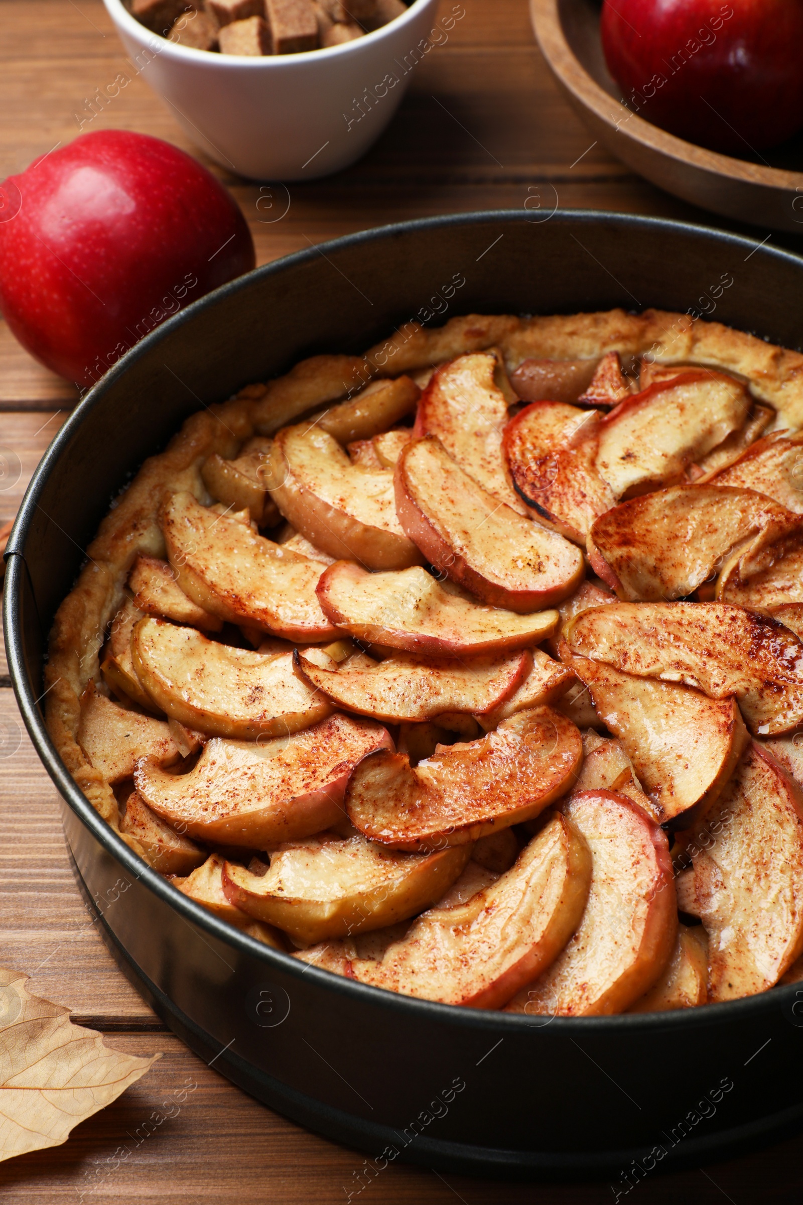 Photo of Delicious apple pie on wooden table, closeup