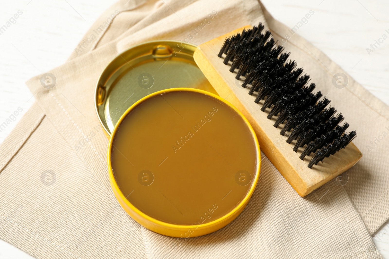 Photo of Shoe care accessories with cloth on white table, closeup