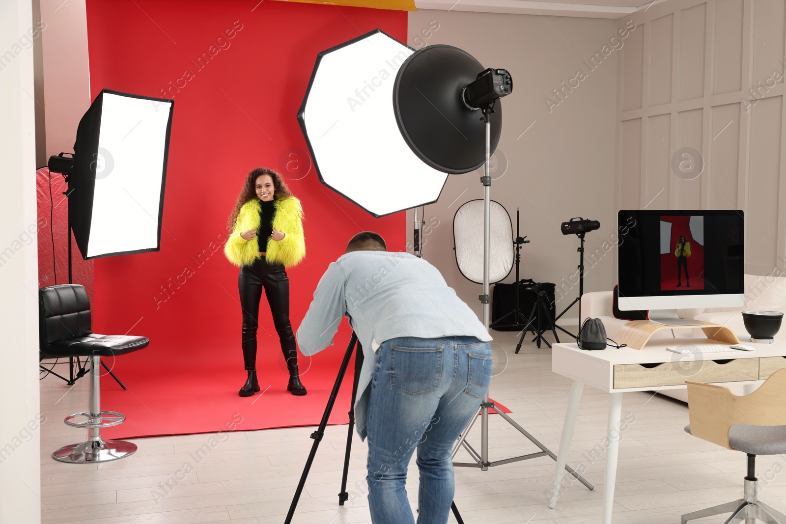 Photo of Beautiful African American model posing for professional photographer in studio