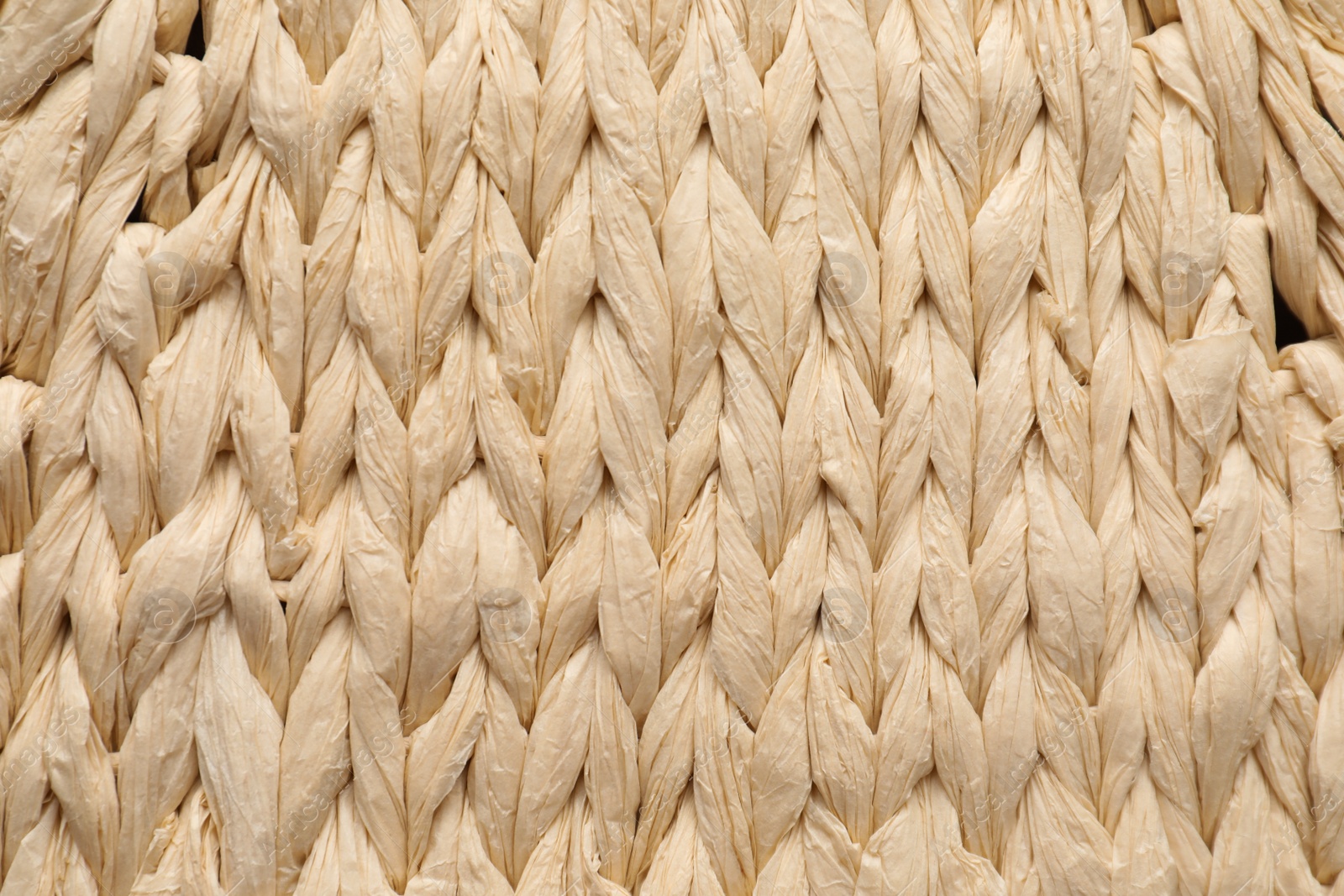 Photo of Elegant woman's straw bag as background, closeup