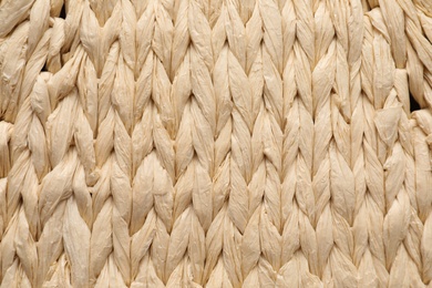 Elegant woman's straw bag as background, closeup