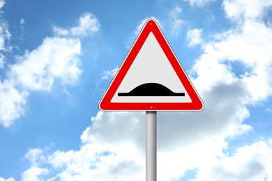 Image of Road sign Speed Bump outdoors against blue sky
