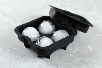 Photo of Frozen ice balls in mold on grey table