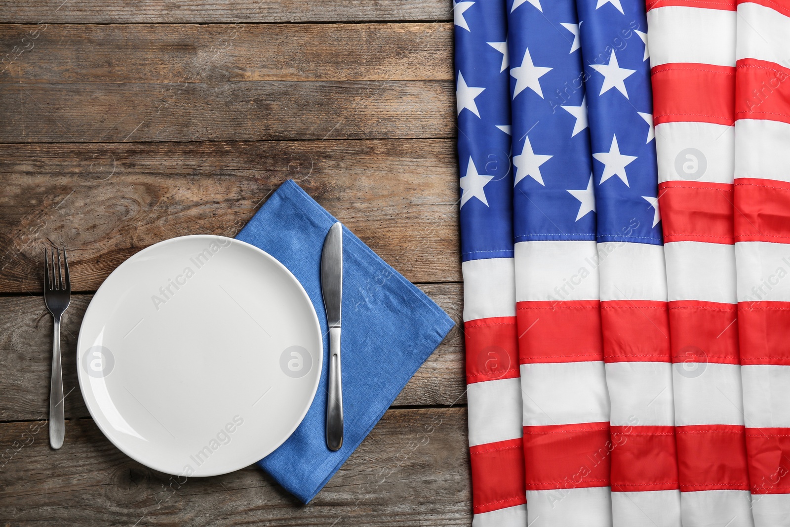 Photo of Patriotic table setting with USA flag on wooden background, flat lay