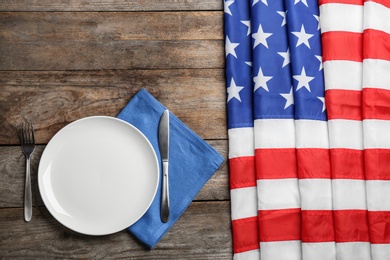 Photo of Patriotic table setting with USA flag on wooden background, flat lay