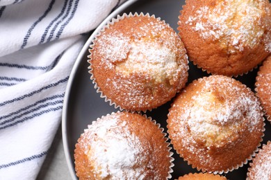 Photo of Delicious sweet muffins on grey table, top view