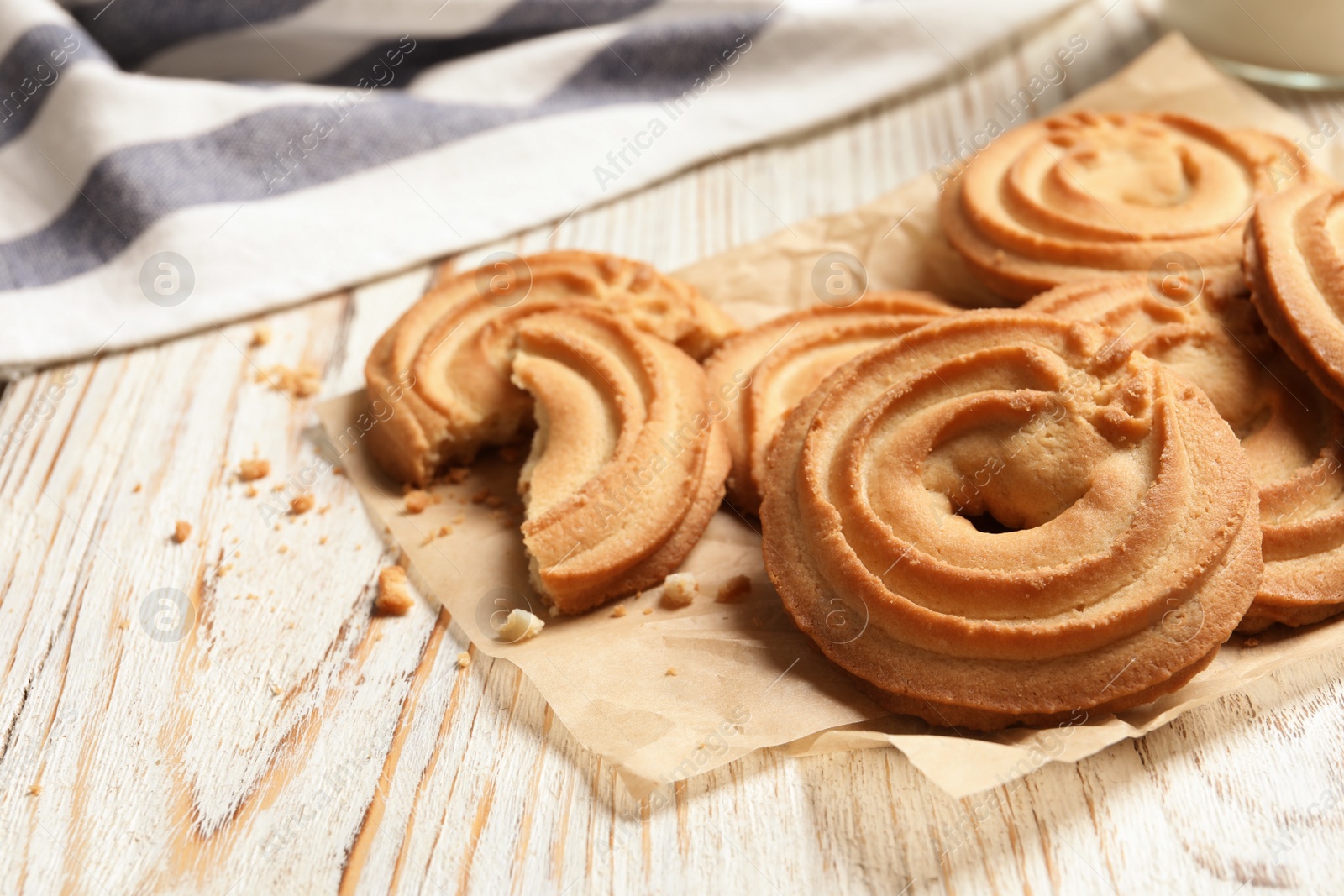 Photo of Tasty Danish butter cookies on wooden background. Space for text