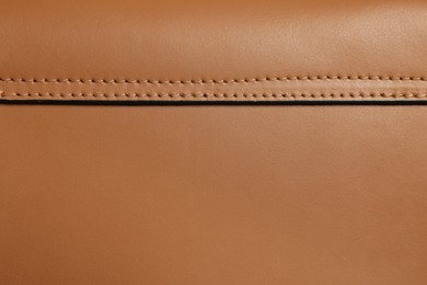 Photo of Brown natural leather with seams as background, top view