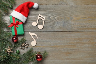 Photo of Flat lay composition with music notes on wooden background, space for text. Christmas celebration