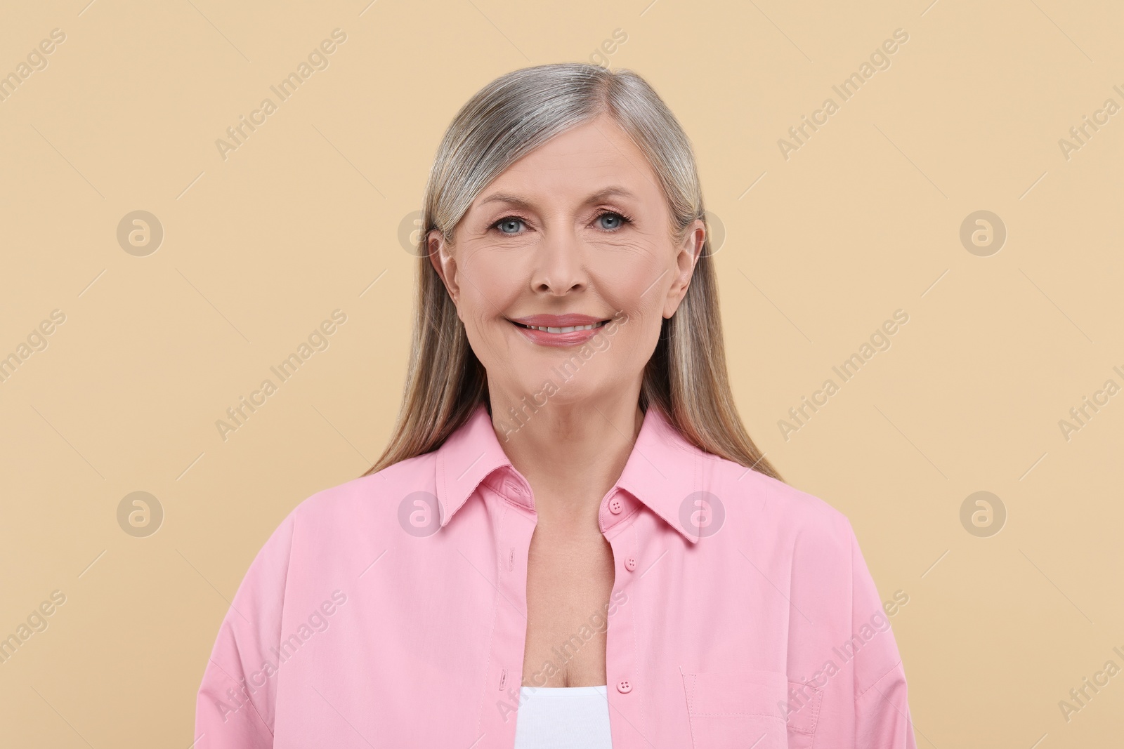 Photo of Portrait of beautiful senior woman on beige background