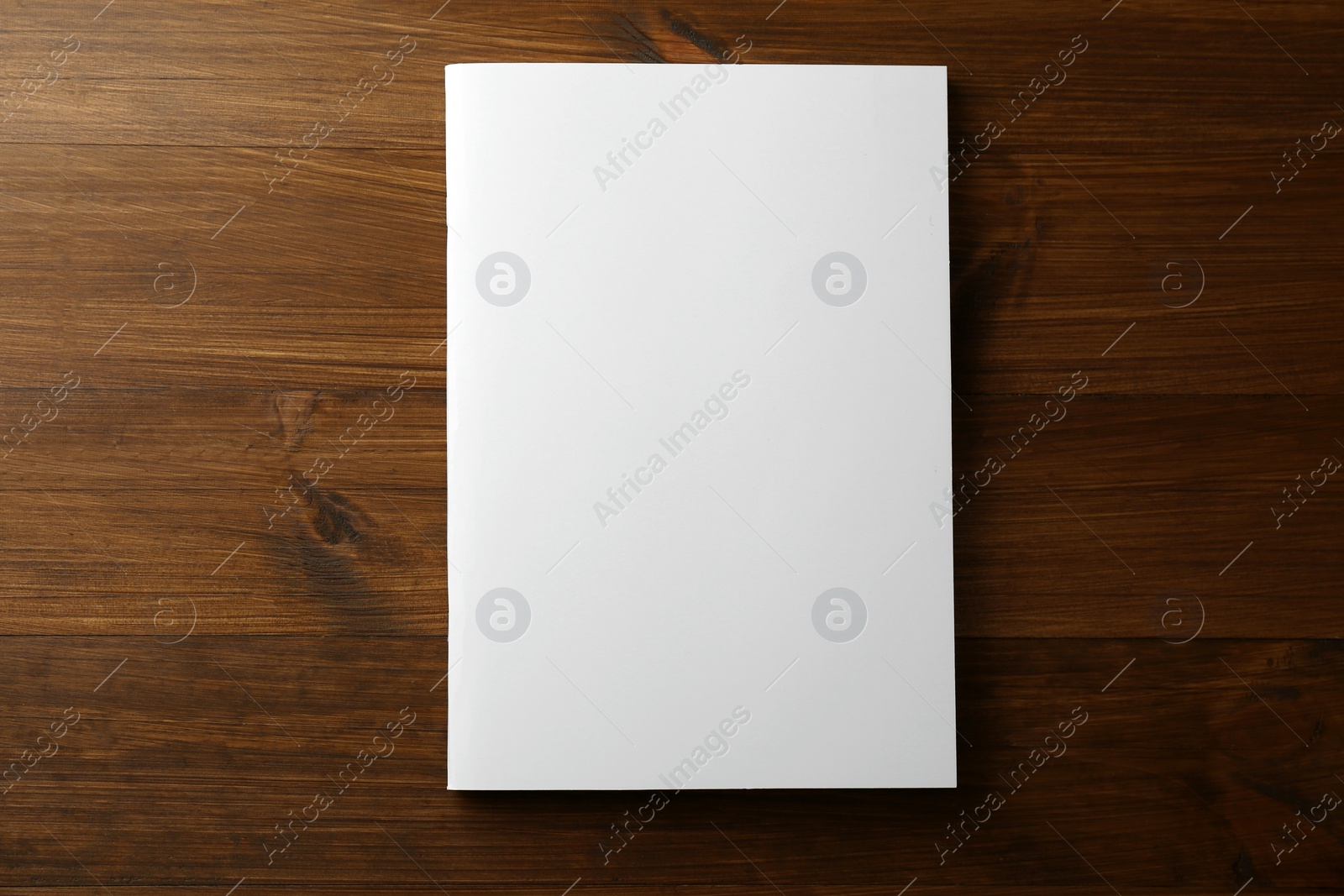 Photo of Blank paper brochure on wooden table, top view. Mockup for design