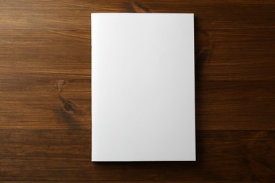 Blank paper brochure on wooden table, top view. Mockup for design