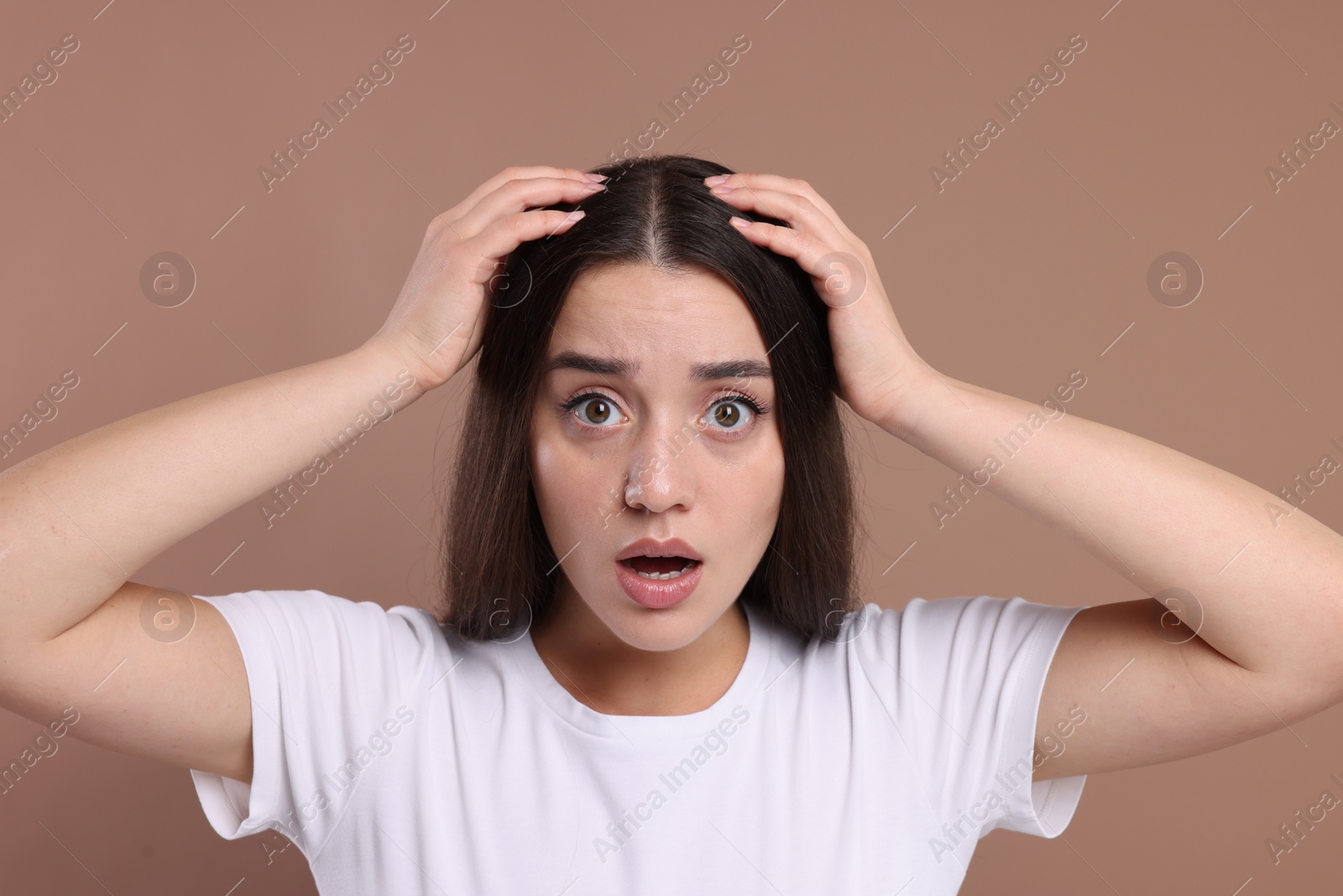 Photo of Emotional woman with healthy hair on beige background. Dandruff problem