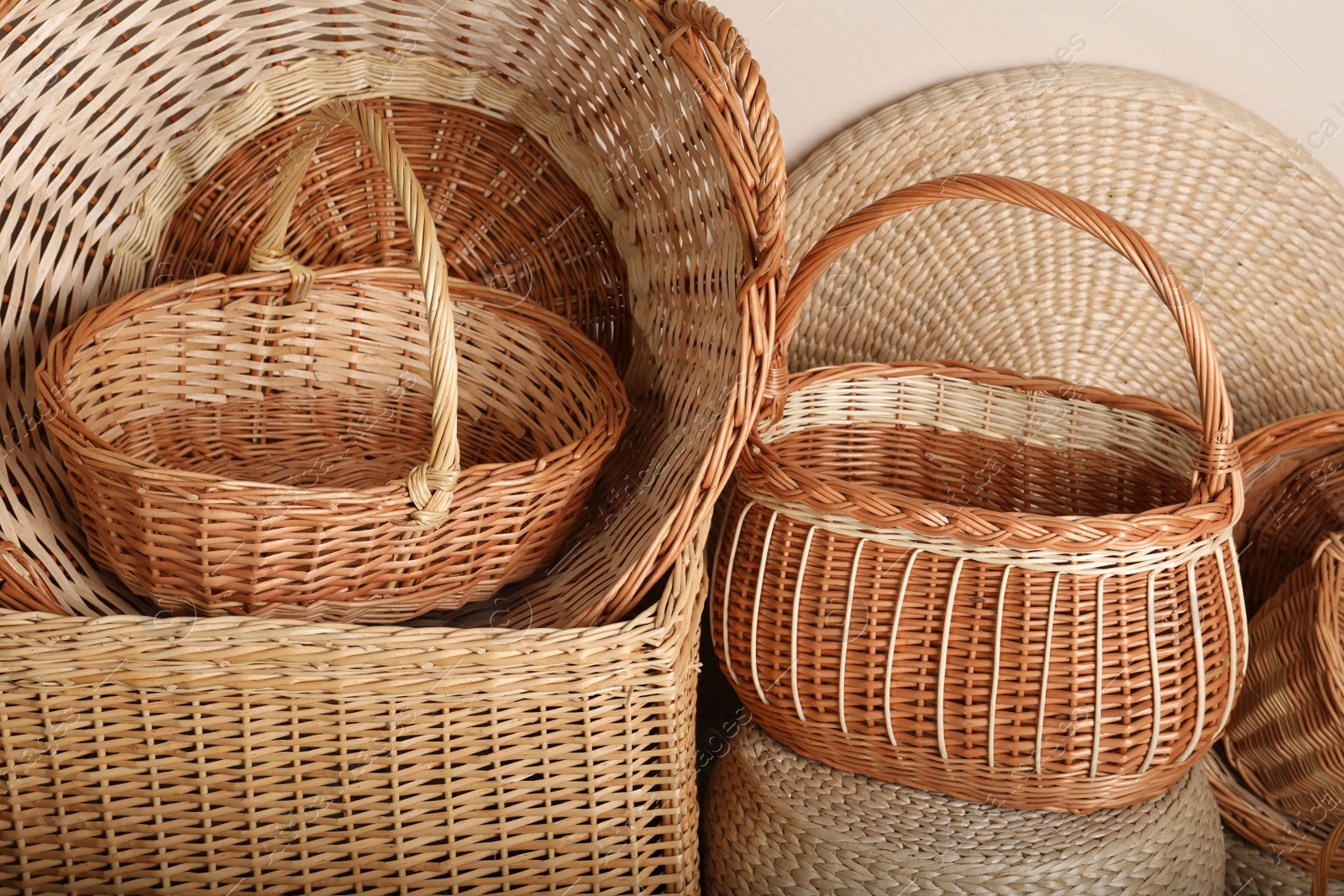 Photo of Many different wicker baskets made of natural material as background, closeup